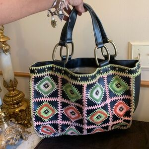 Black leather bag with crochet